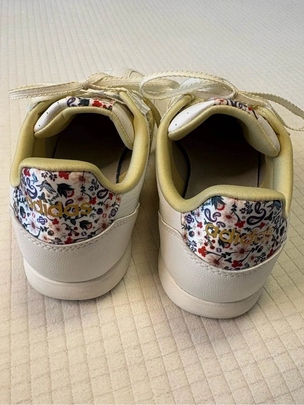 Adidas cream colored sneakers with floral accents